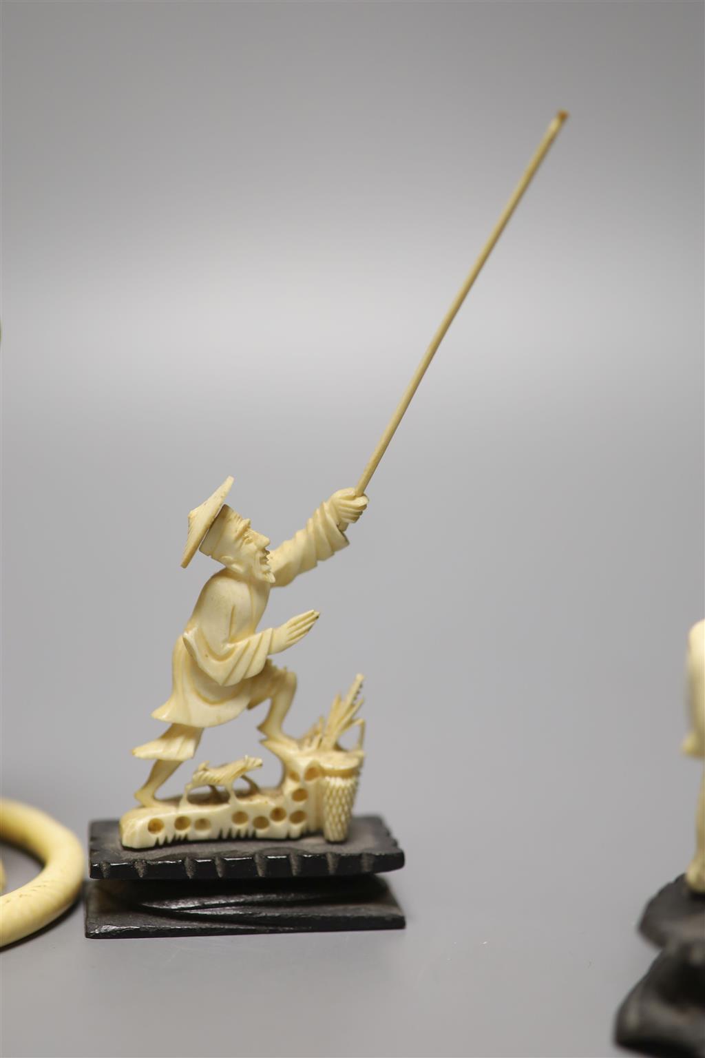 A Japanese carved ivory figure, male with brush, Meiji period, an elephant, a fisherman and a bangle